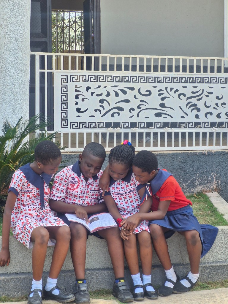 Young learners reading together on the Early Grade Campus