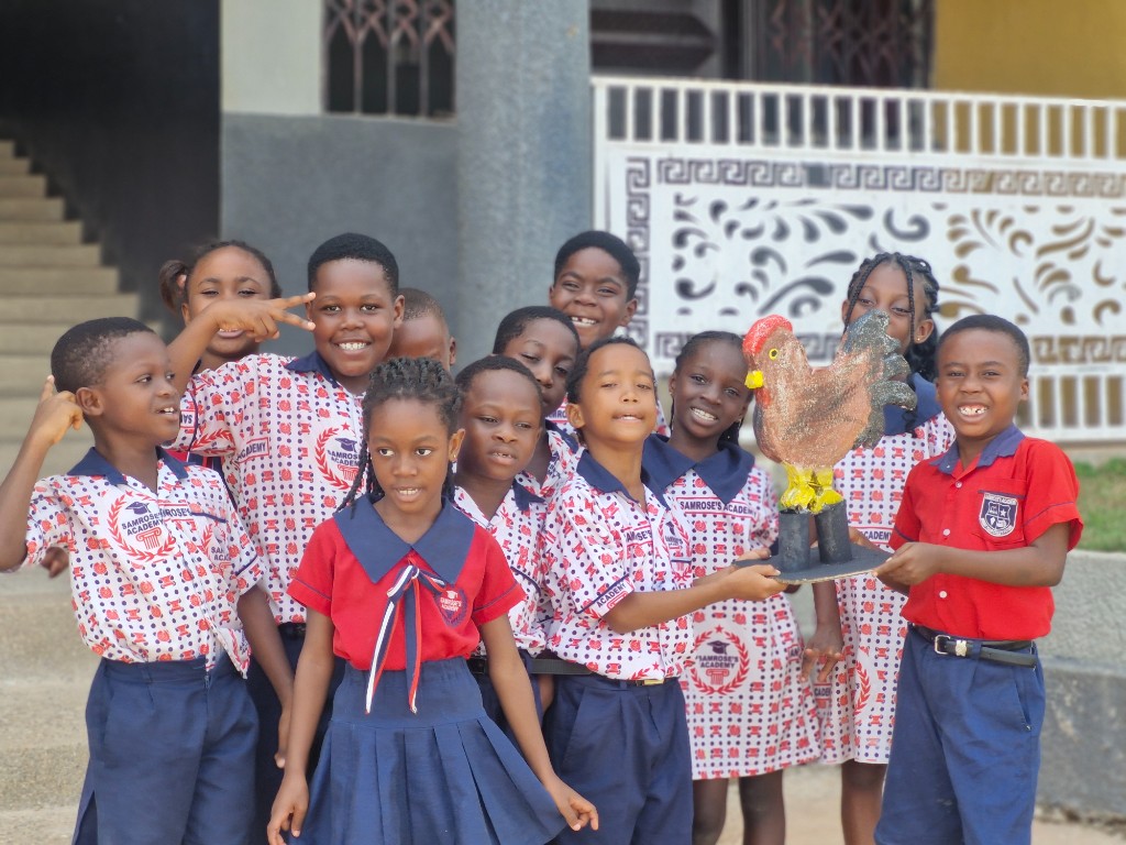 Pupils presenting a painted flower-tree artwork during a creative arts session