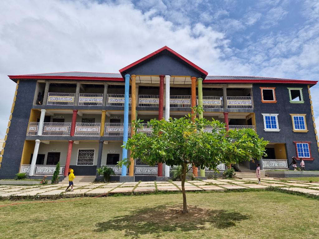 Main Campus three-storey block with colourful pillars at Ahenema Kokoben